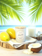 Mango Tango candle in white tin with tropical fruit and palm leaves