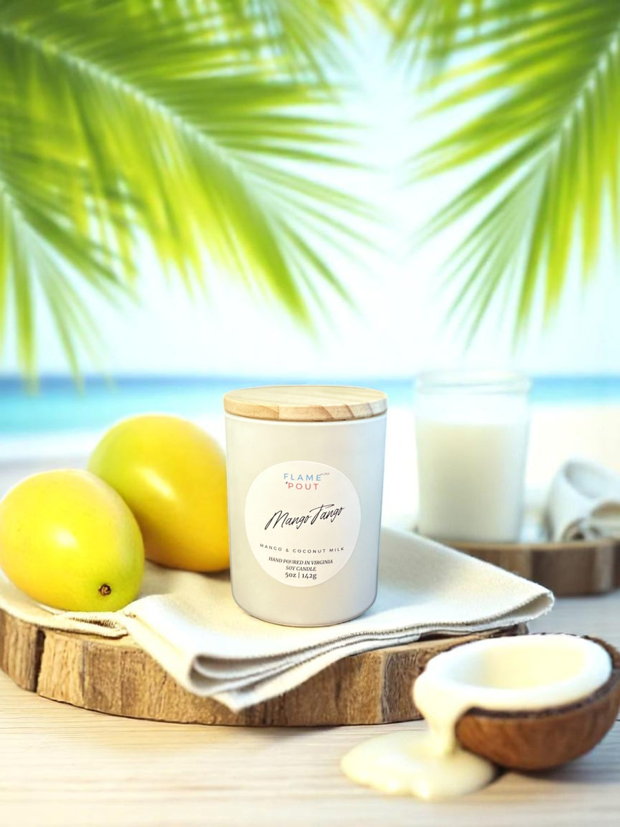 Mango Tango candle in white tin with tropical fruit and palm leaves