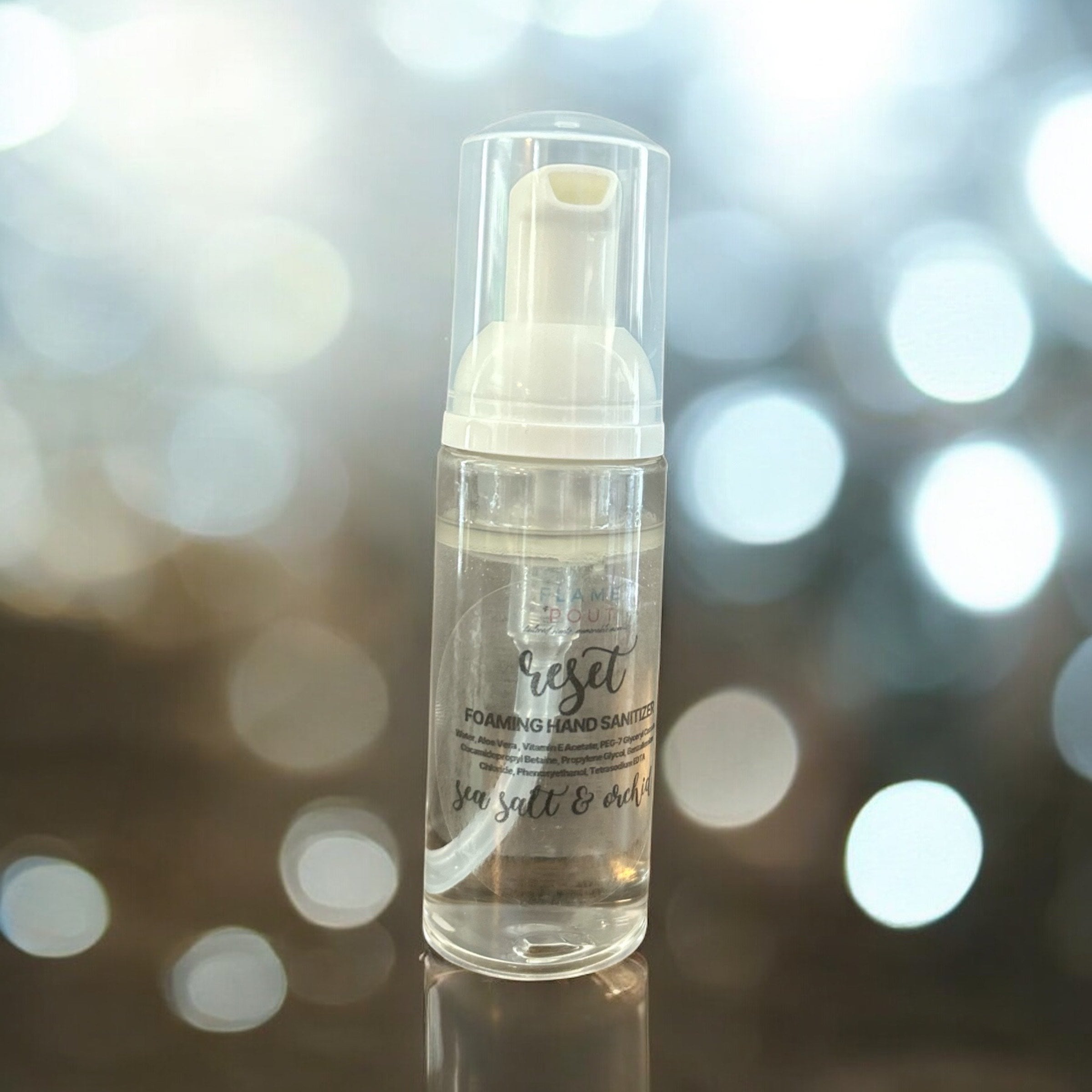 Foaming hand sanitizer bottle labeled 'reset' with a blurred bokeh background